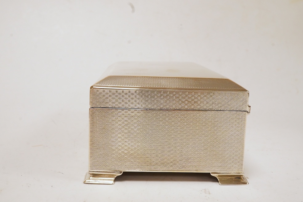 A George V engine turned silver mounted rectangular cigarette box, by Colen Hewer Cheshire, Chester, 1924, 16.6cm. Condition - poor to fair